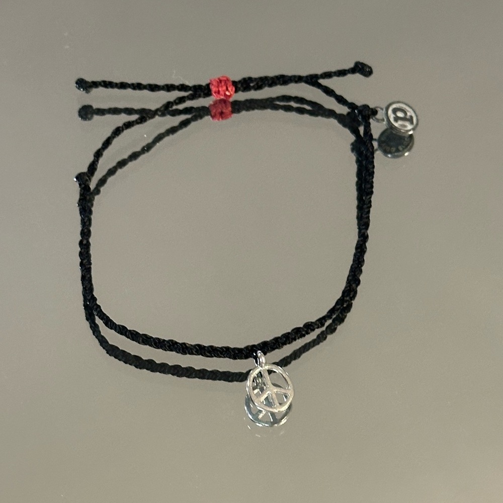 Pura Vida. Black Braided Bracelet with Silver Peace Charm and Red Accent